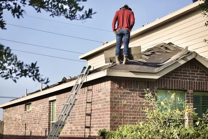 Professional roofer working on a residential roof in Profit Acres
